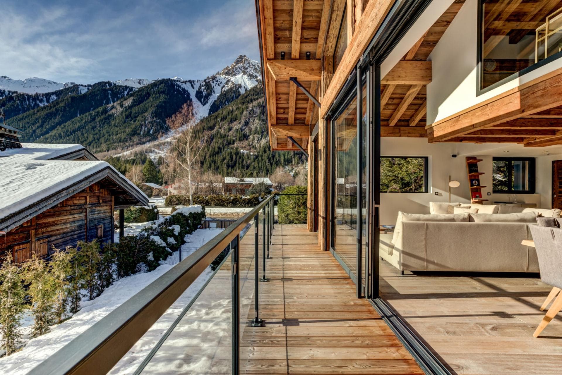 Covered balcony with mountain views and floor-to-ceiling sliding glass doors