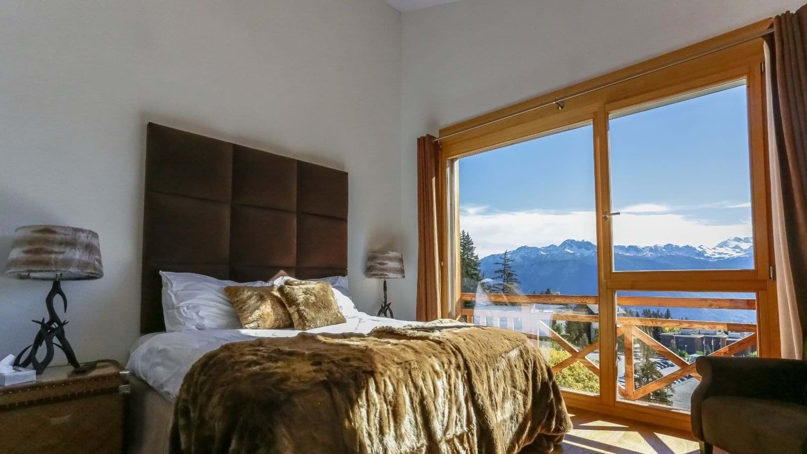Bedroom with queen bed and panoramic mountain views