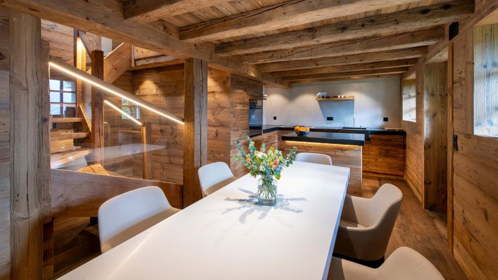 Open-plan dining area and kitchen with original reclaimed timber beams