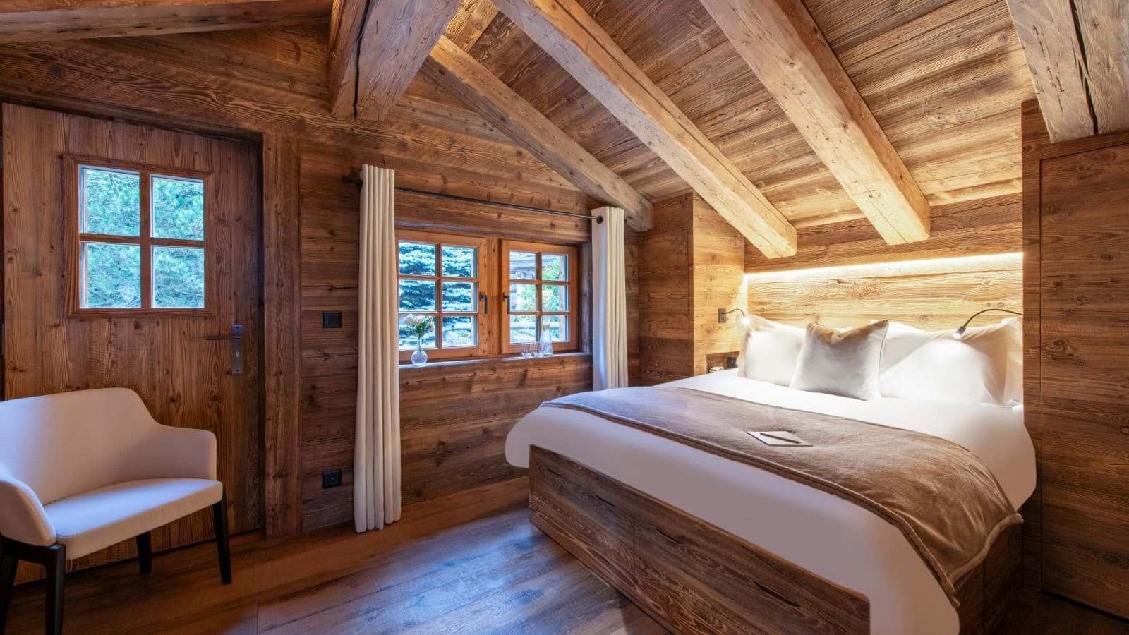 Guest bedroom with queen bed and integrated reading lights