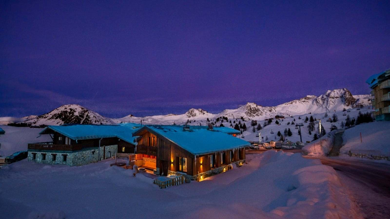 Ski-in/ski-out chalet exterior with direct mountain access and ski lift views