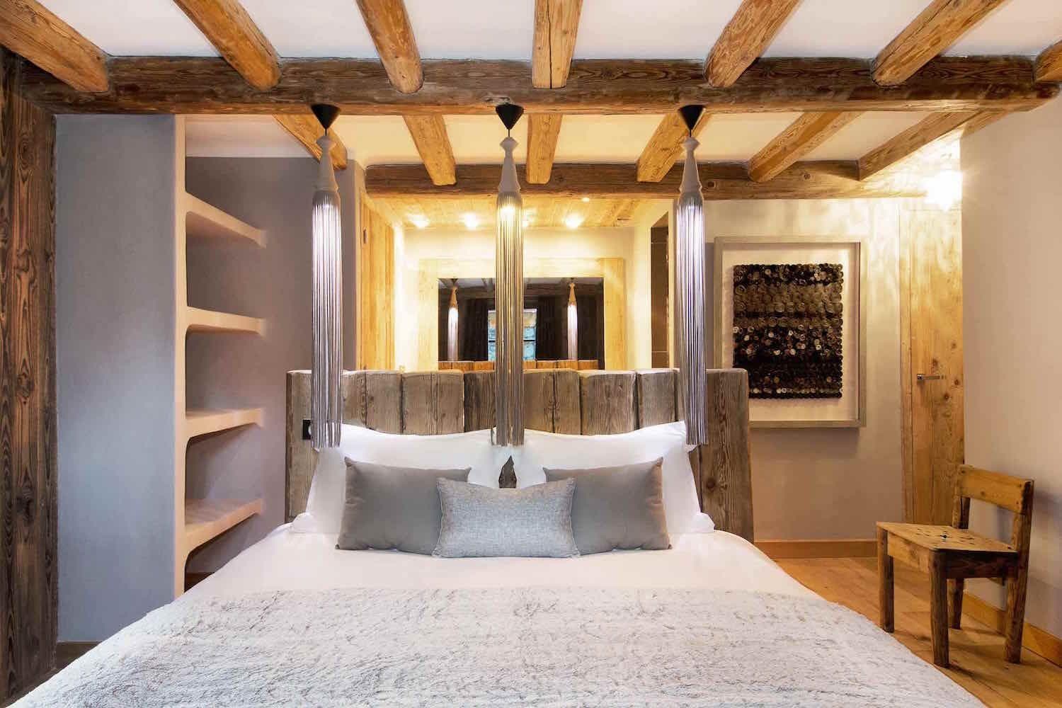 Bedroom with exposed timber beams and built-in wall shelving
