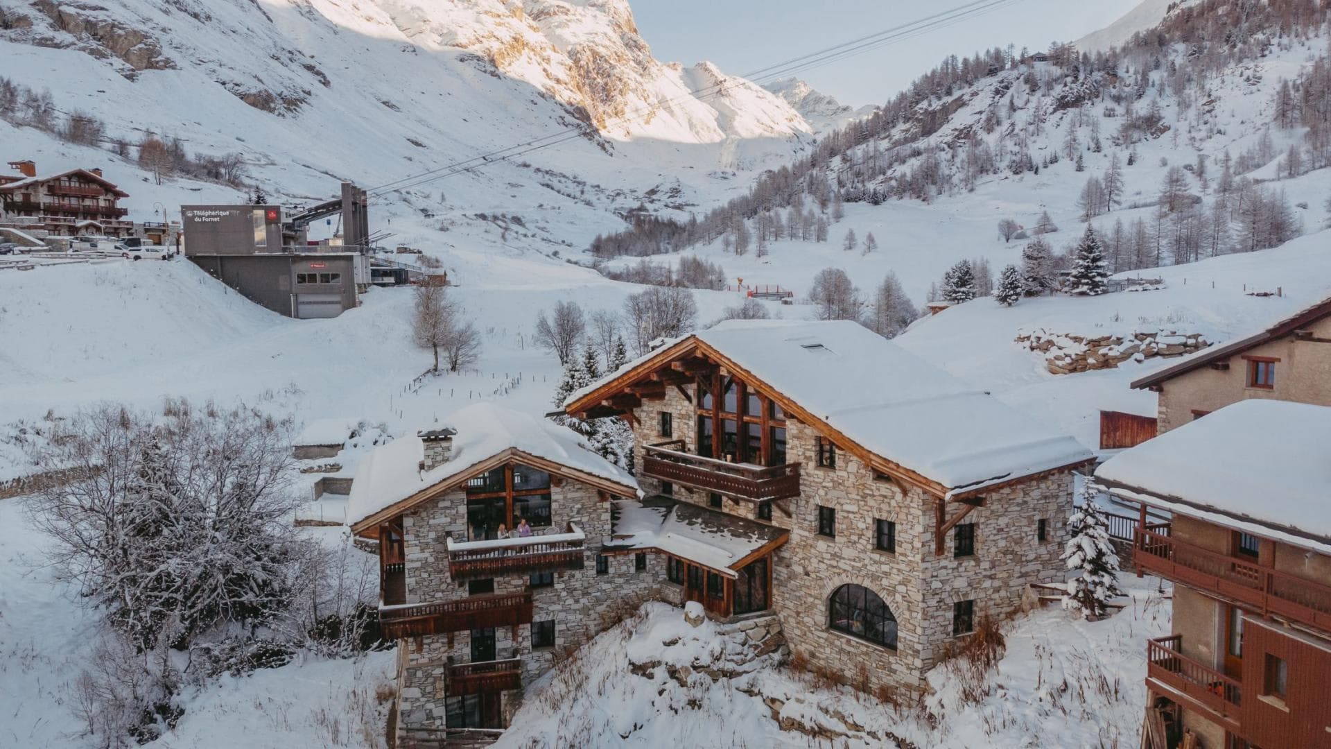 Stone chalet exterior adjacent to Fornet gondola station