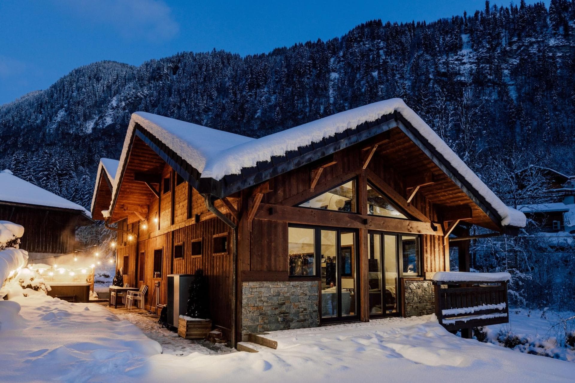 Chalet exterior with mountain views and outdoor hot tub