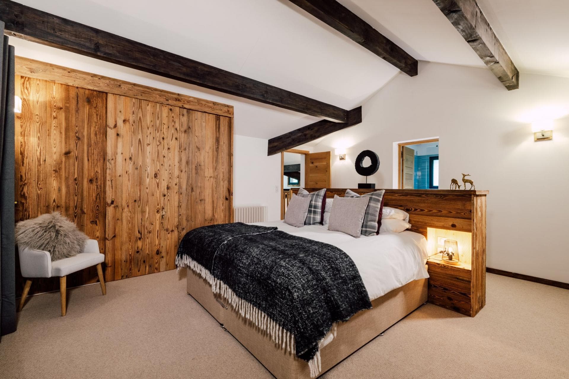 Primary bedroom with king bed and built-in reclaimed wood closets