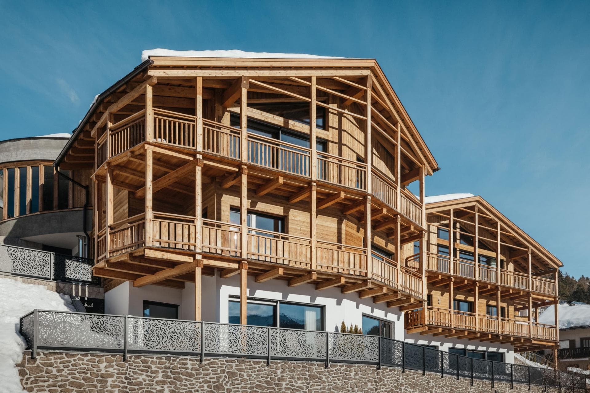 Chalet exterior with three levels of private wrap-around timber balconies