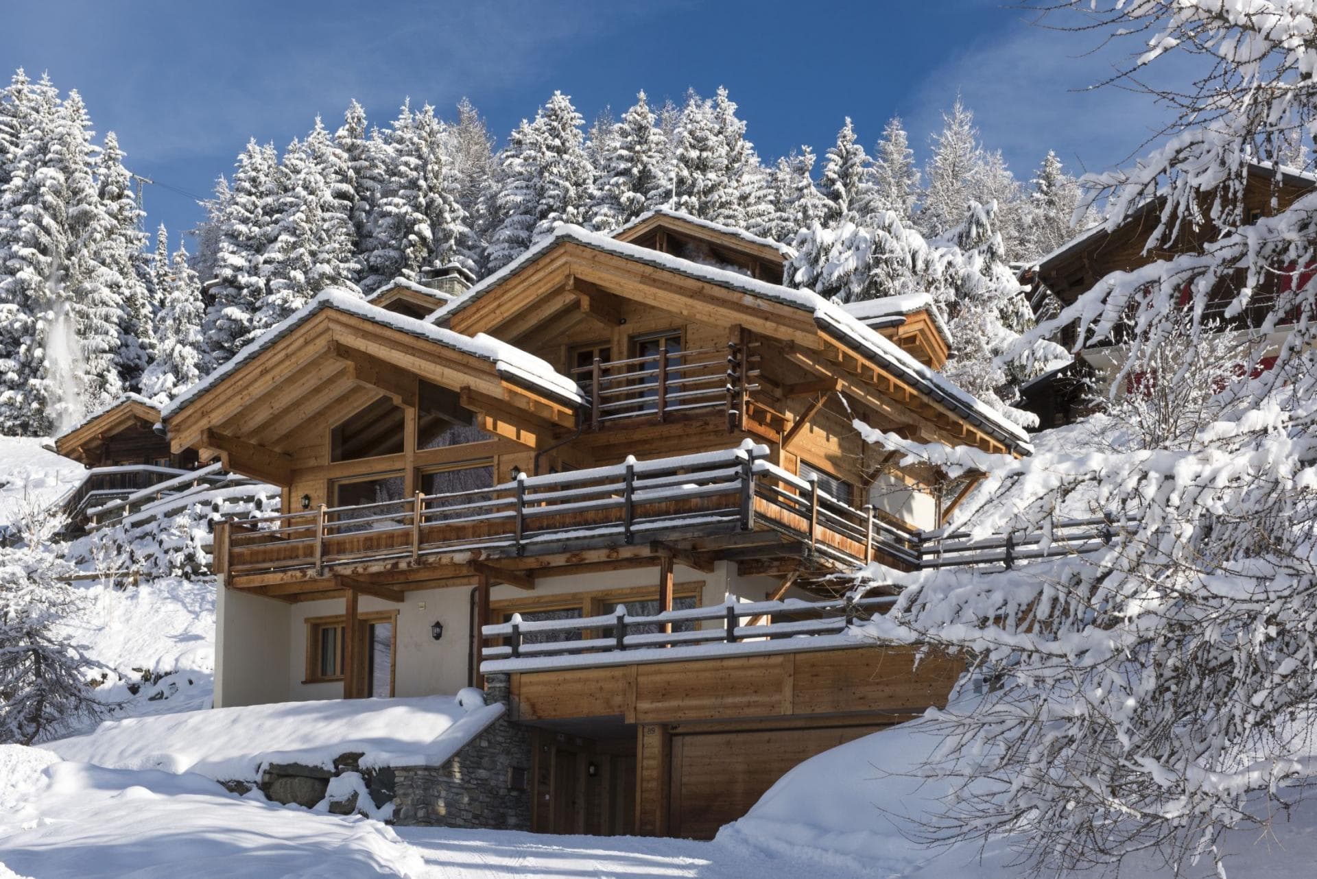 Ski-in chalet with wrap-around balconies and private garage parking