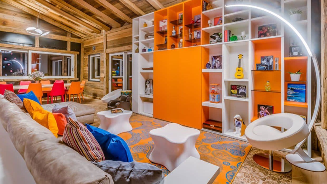 Living area with floor-to-ceiling shelving and dining table for eight