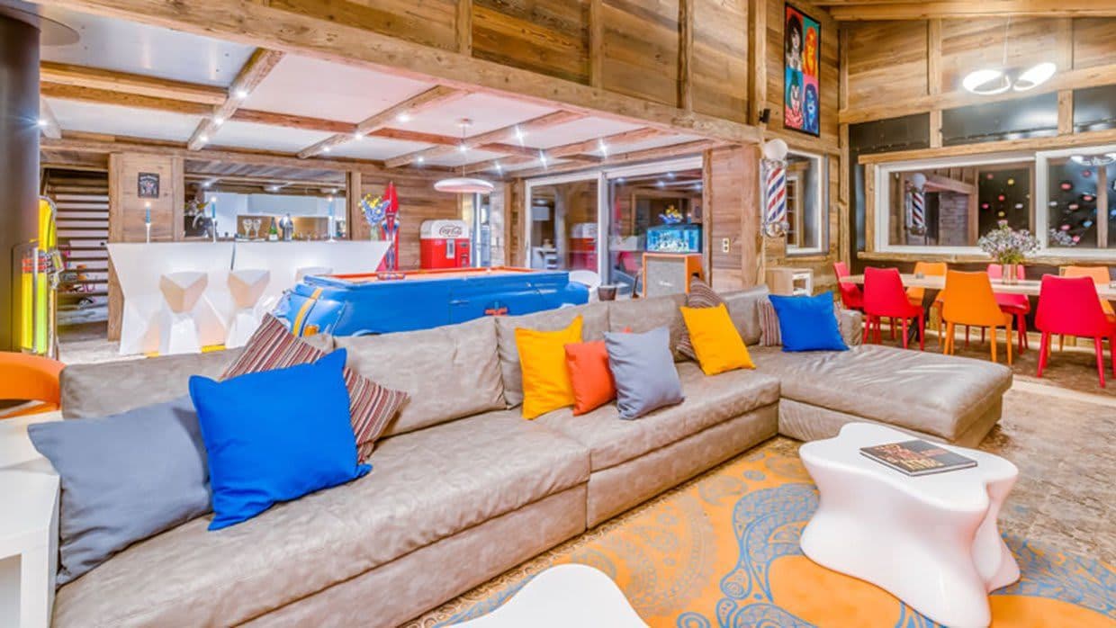 Open-plan game room with pool table, bar seating, and lounge area