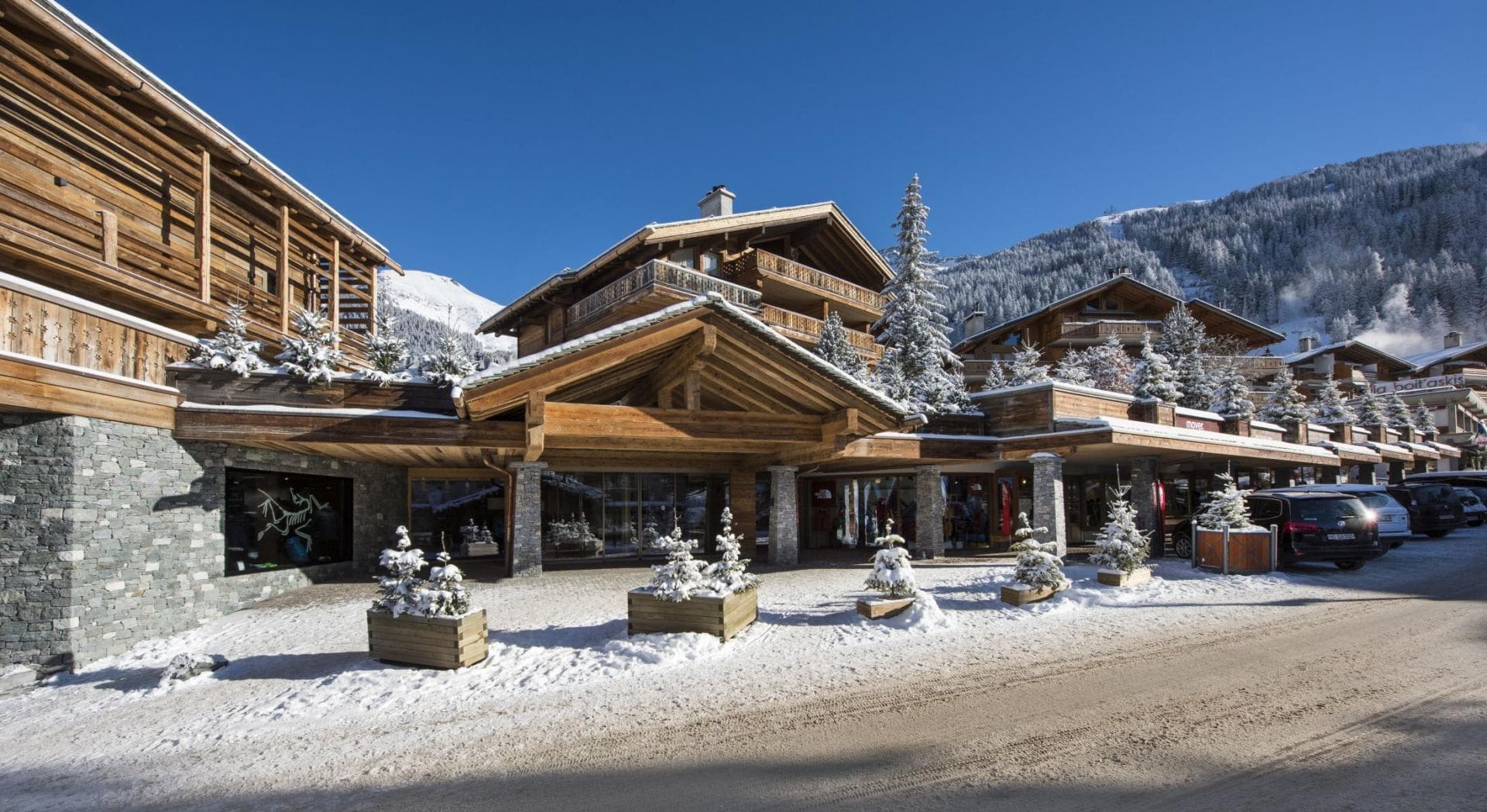 Chalet entrance and ground-floor ski shop with mountain views