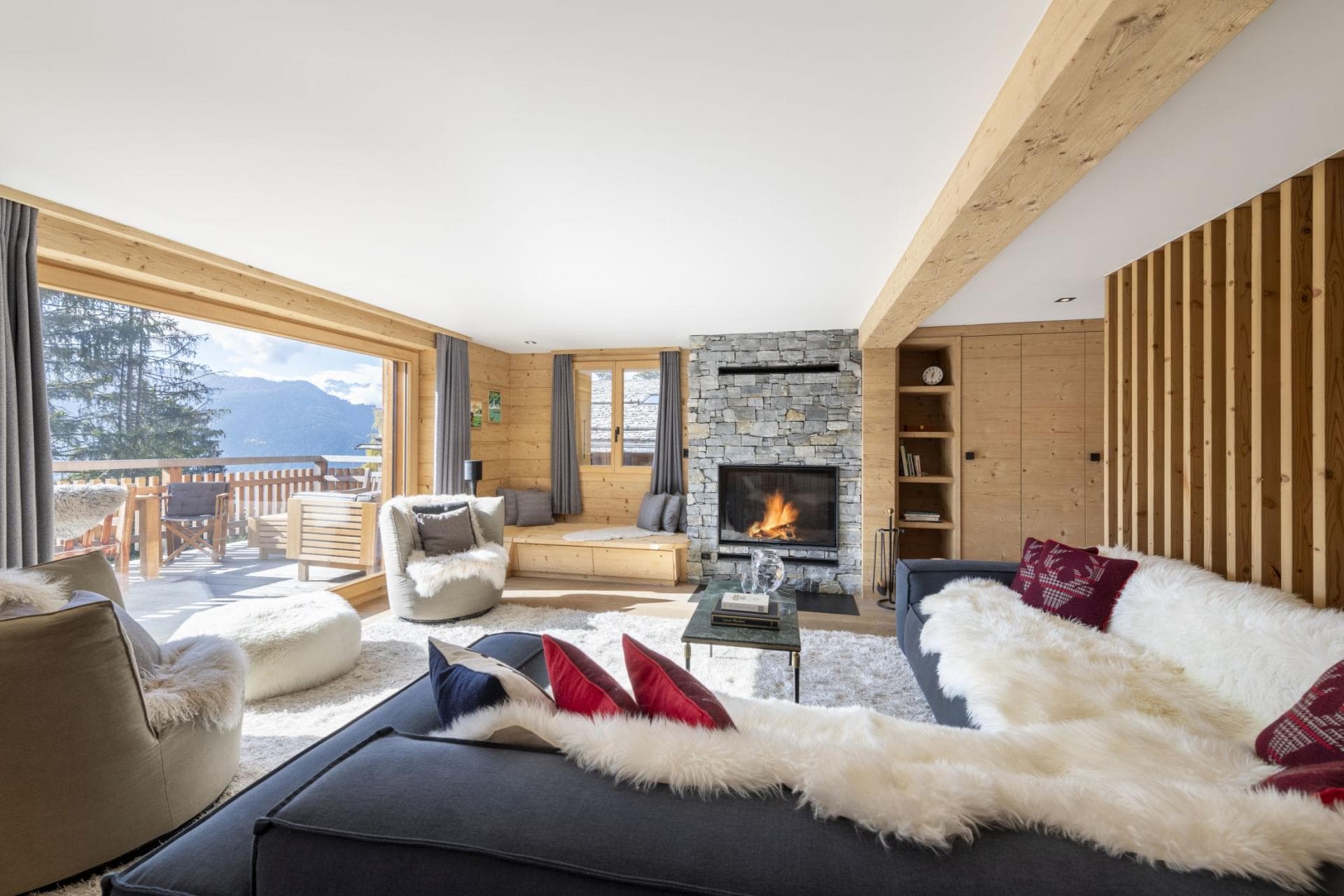 Living area with wood-burning fireplace and mountain-view terrace access