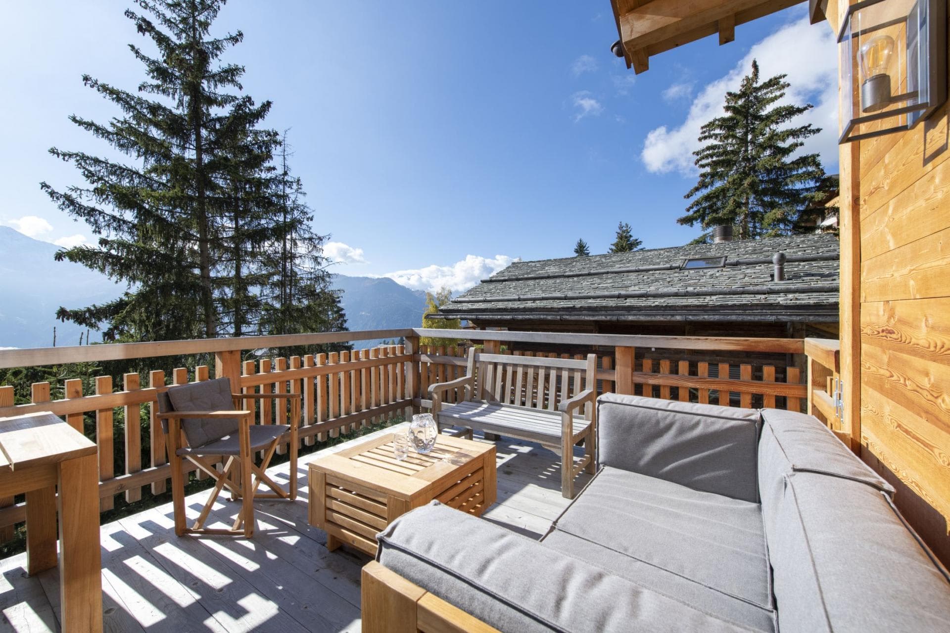 Private balcony with lounge seating and alpine valley views