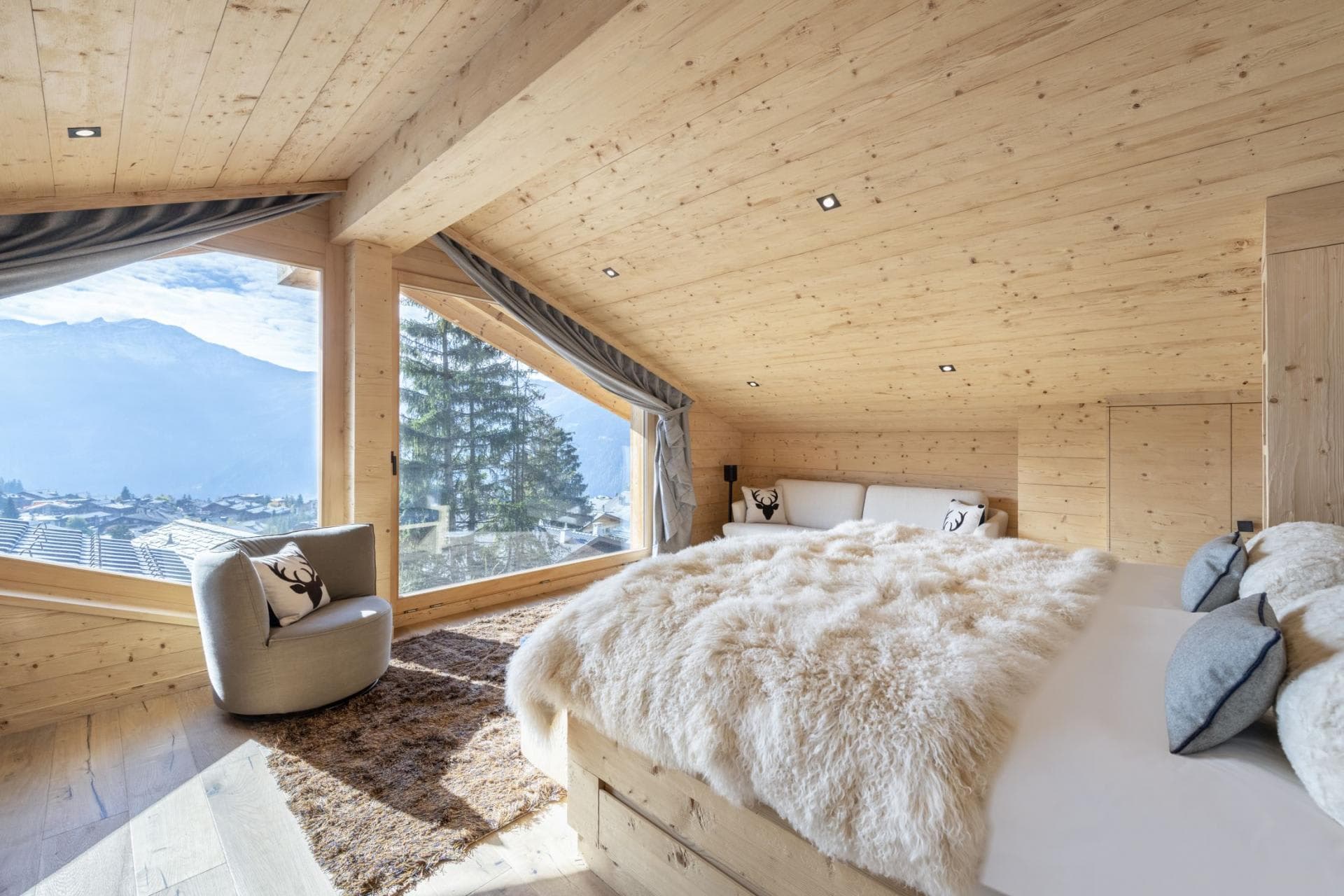 Loft bedroom with village views and integrated wood storage closets