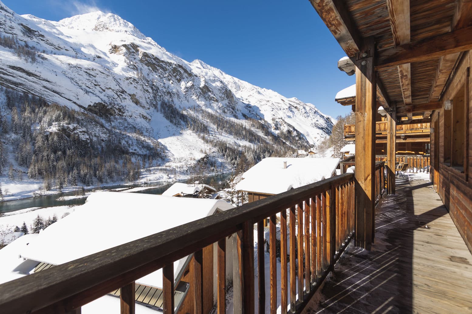 Covered wooden balcony with south-facing mountain and valley views