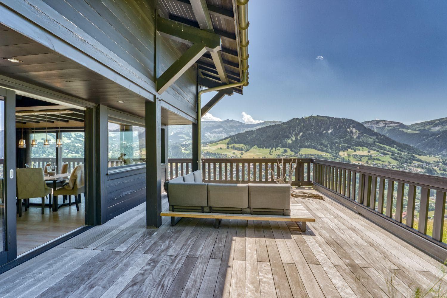 Private deck with sectional seating and panoramic alpine views