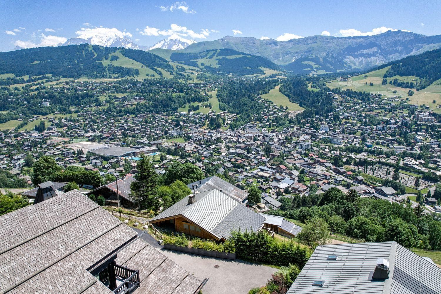 Aerial view of alpine village with Mont Blanc massif in background