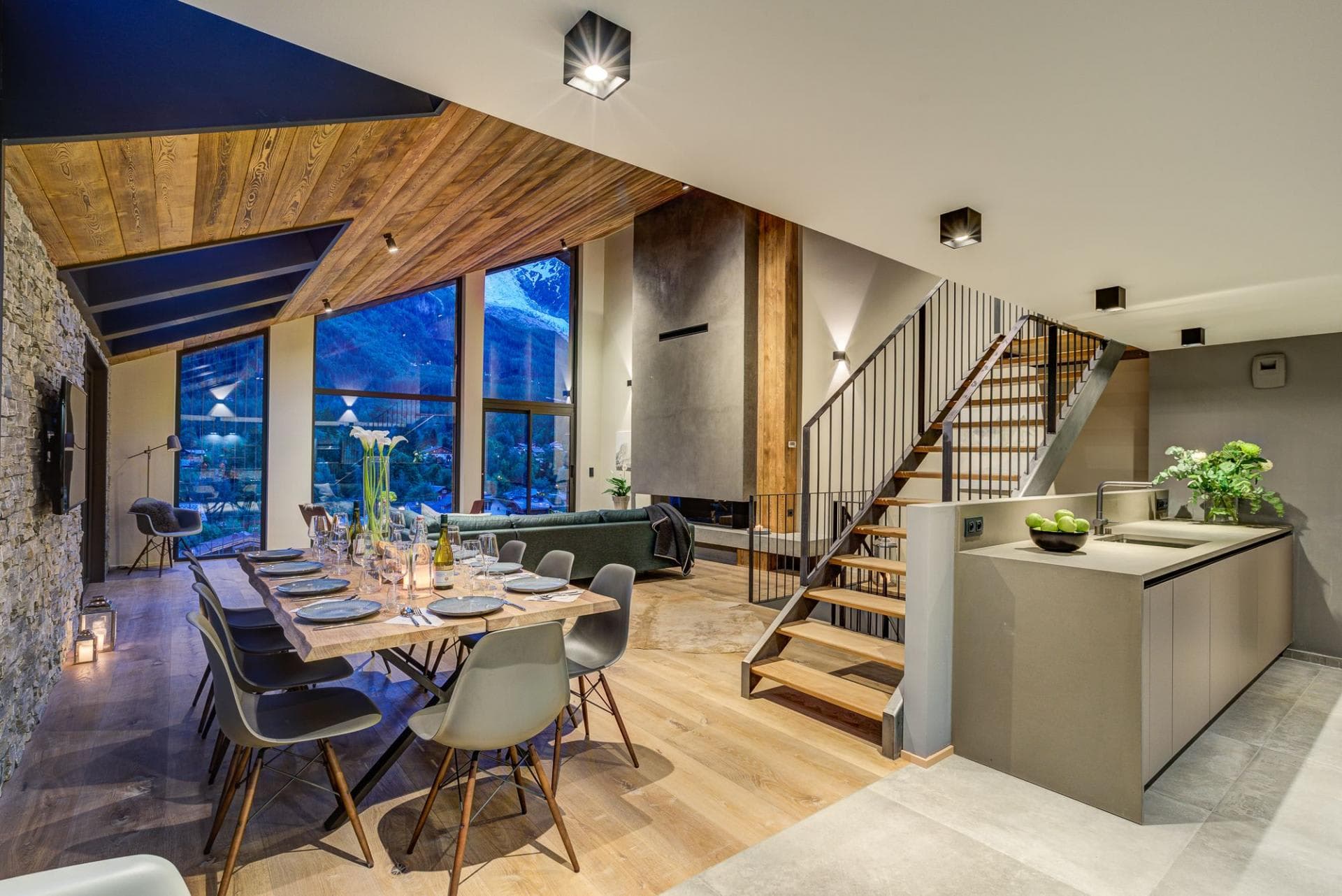 Open-plan dining area seats 8; floor-to-ceiling windows with mountain views