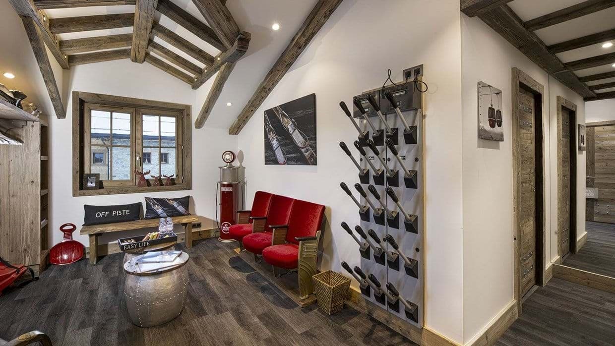 Ski boot room with wall-mounted heated dryers and vintage theater seating