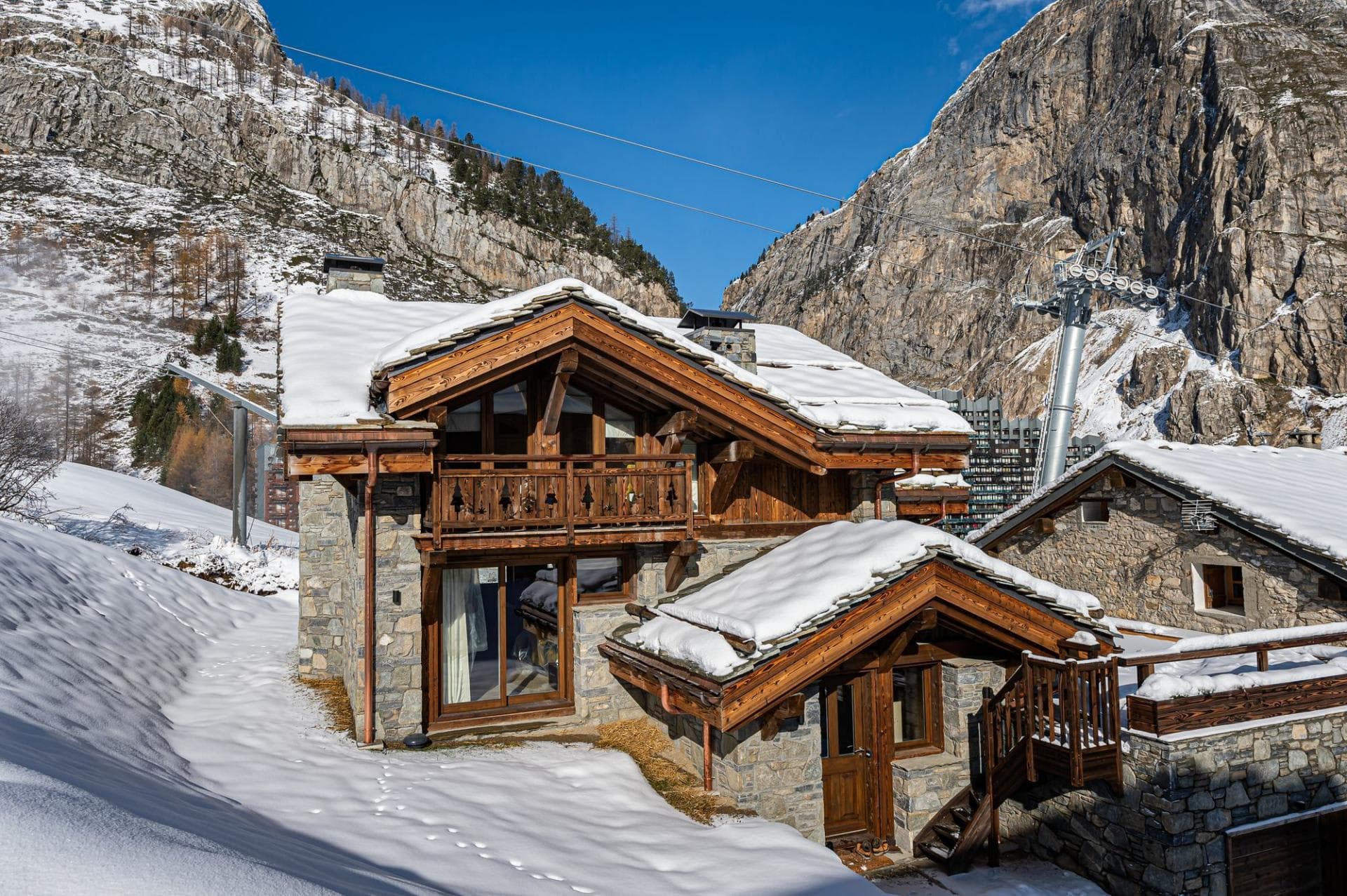 Stone and timber chalet exterior adjacent to ski lift