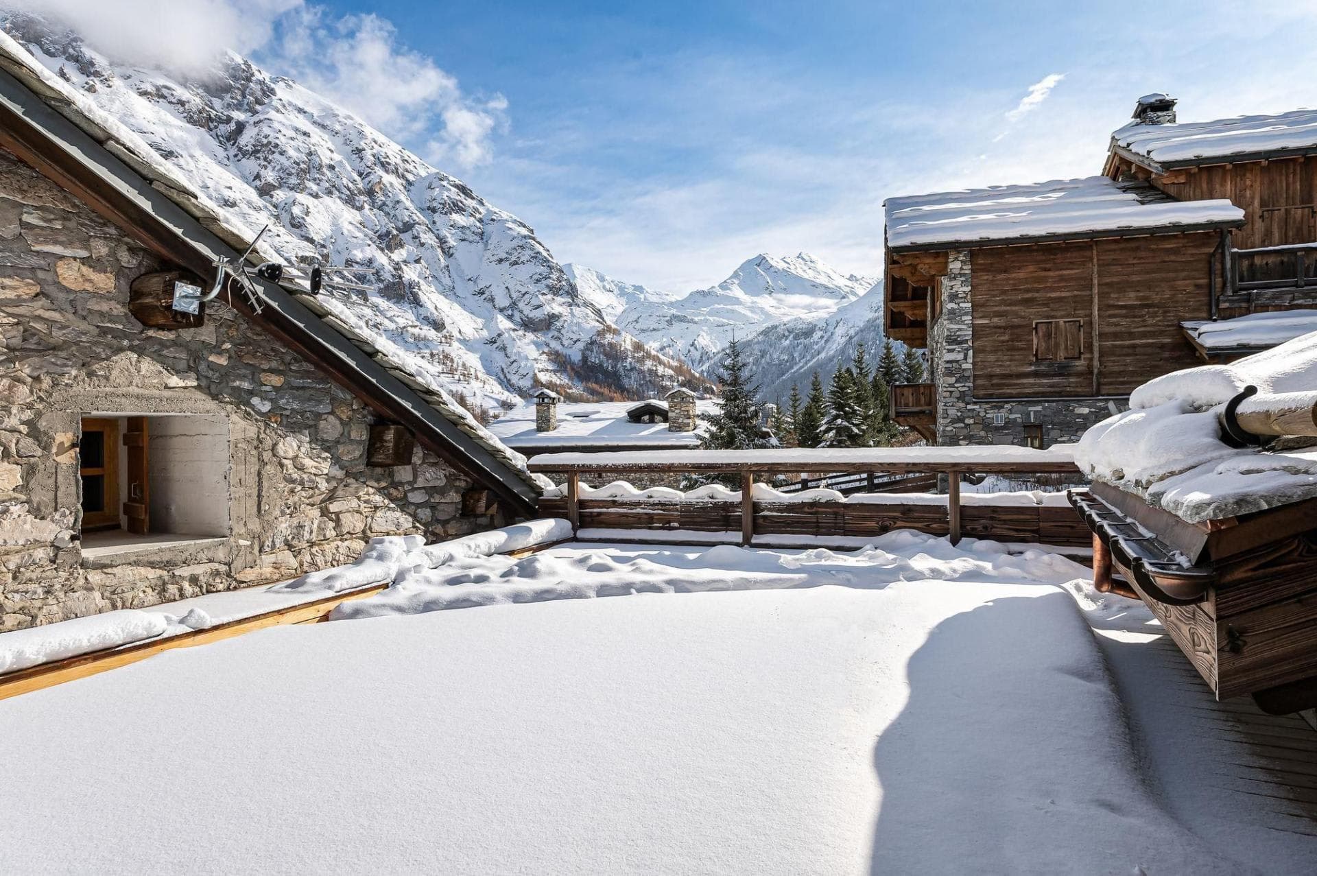 Snow-covered terrace with panoramic views of high alpine peaks