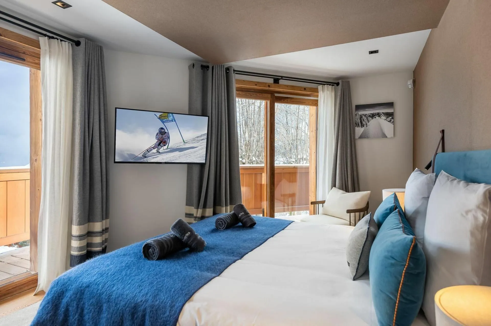 Double bedroom with television and glazed doors