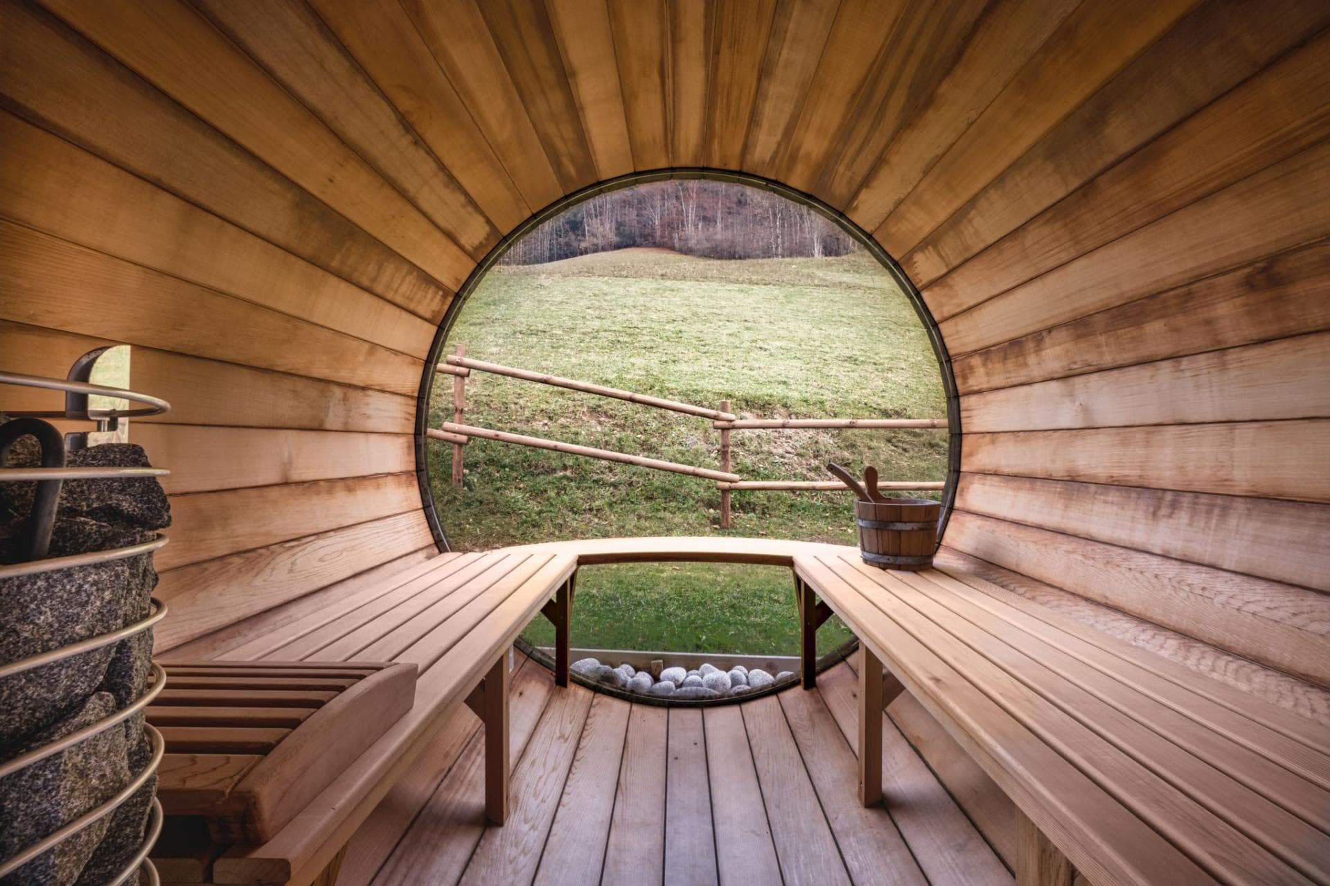 Cedar barrel sauna with electric stone heater and panoramic meadow views