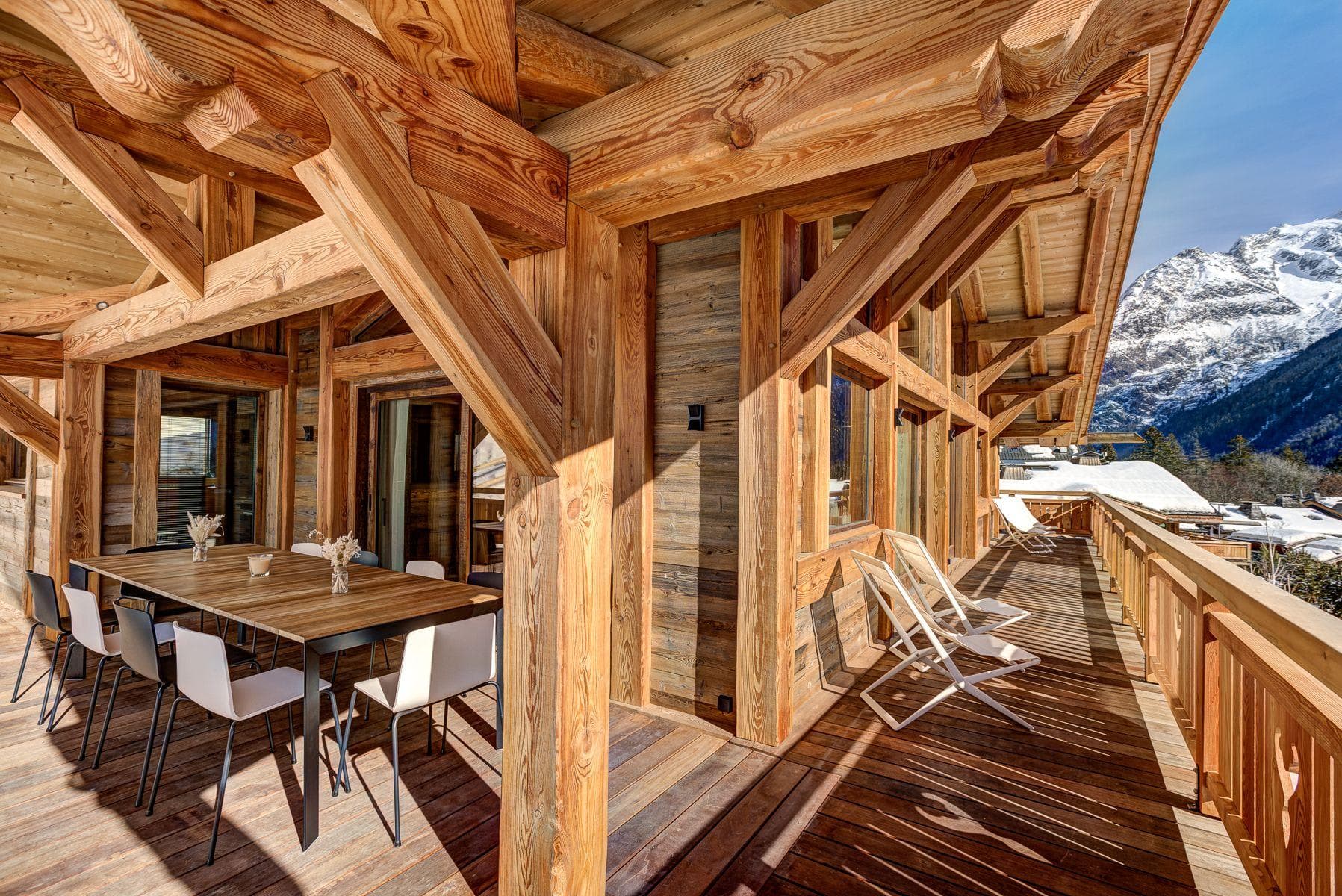 Covered timber balcony with dining for 8 and mountain views