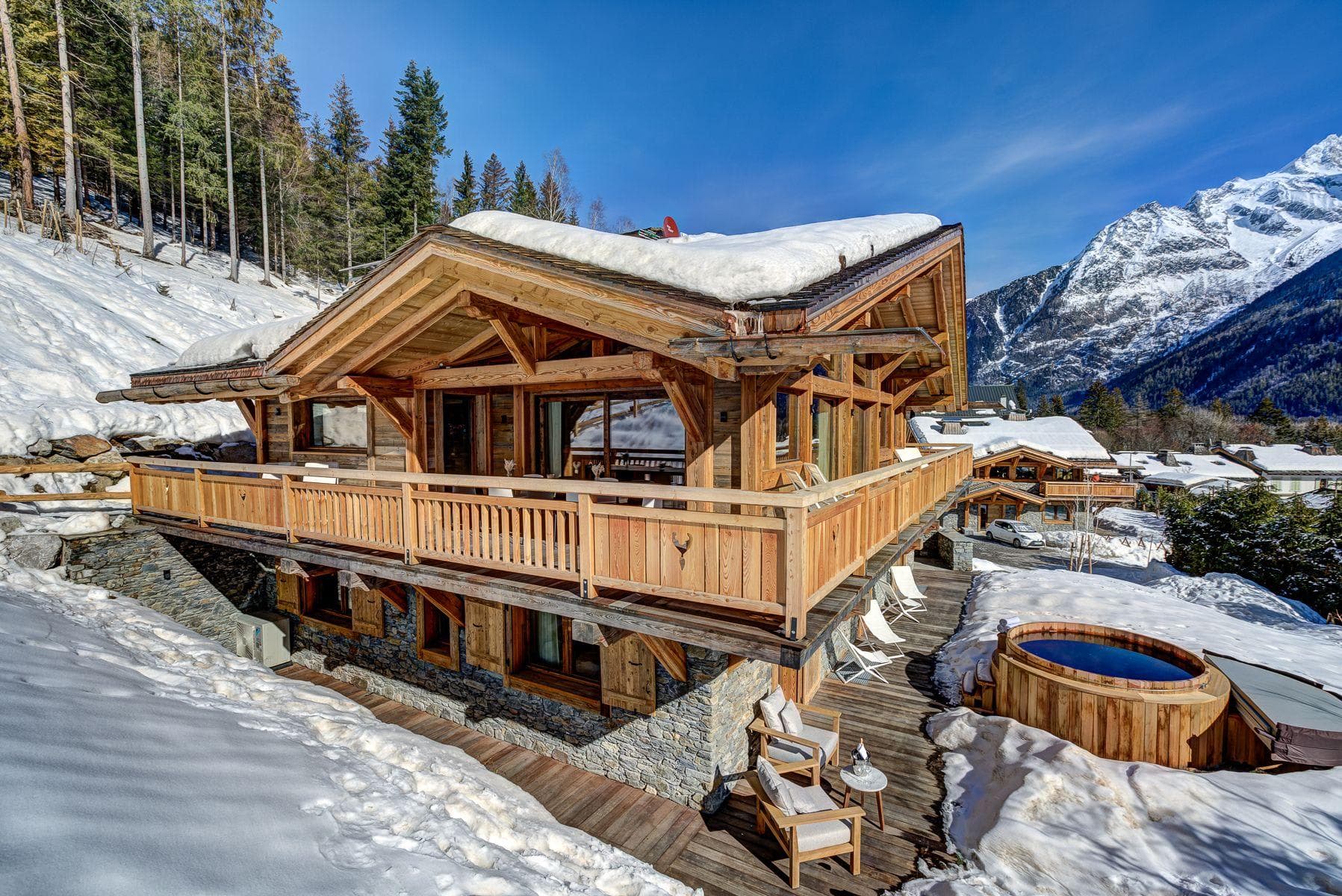 Chalet exterior with wrap-around balcony and private cedar hot tub
