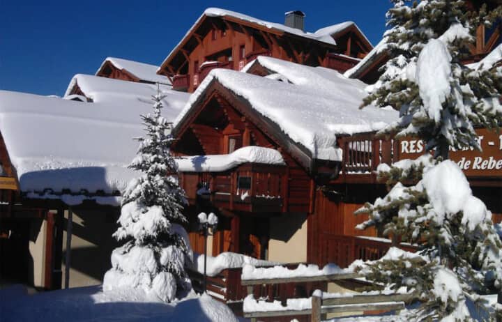 Ski chalet exterior with private balcony and close proximity to resort restaurants