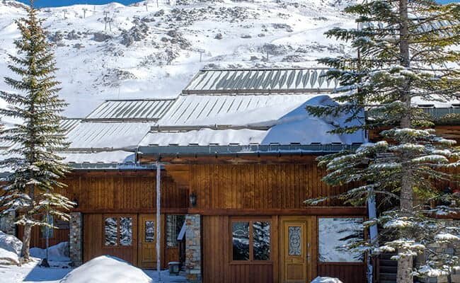Ski-in/ski-out chalet exterior with direct access to mountain trails