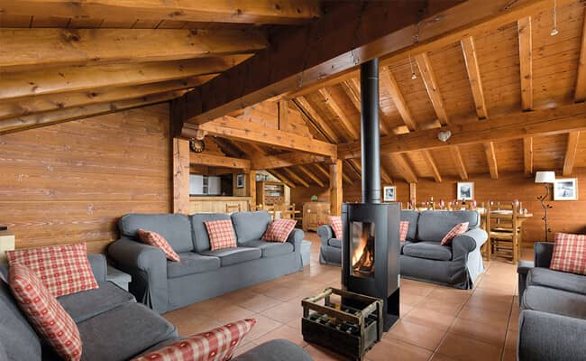 Living area with wood-burning stove and seating for 12