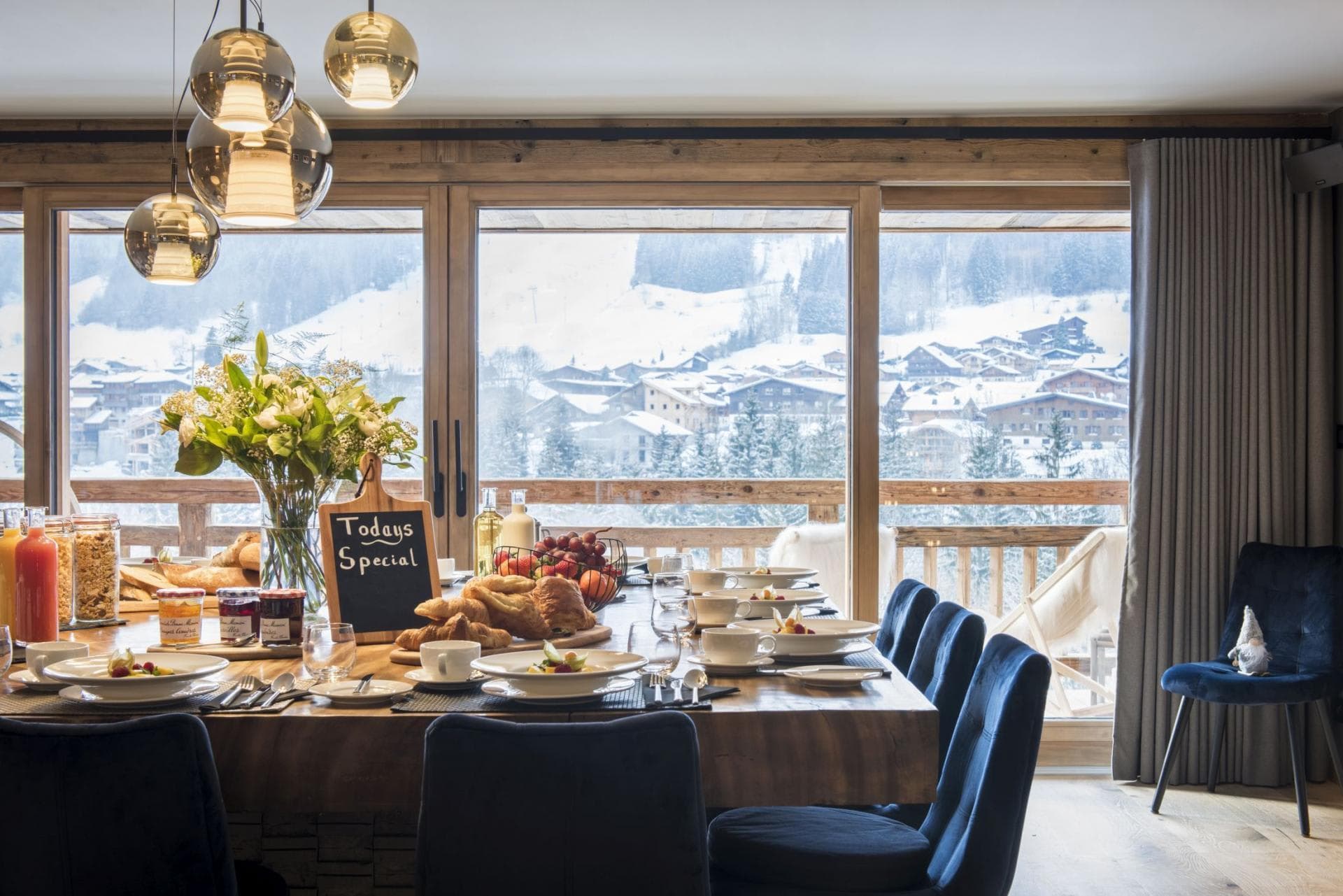 Dining table with seating for 8 and floor-to-ceiling mountain views