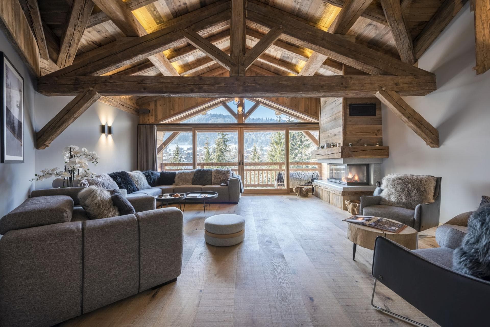Living area with wood-burning fireplace and mountain-facing balcony