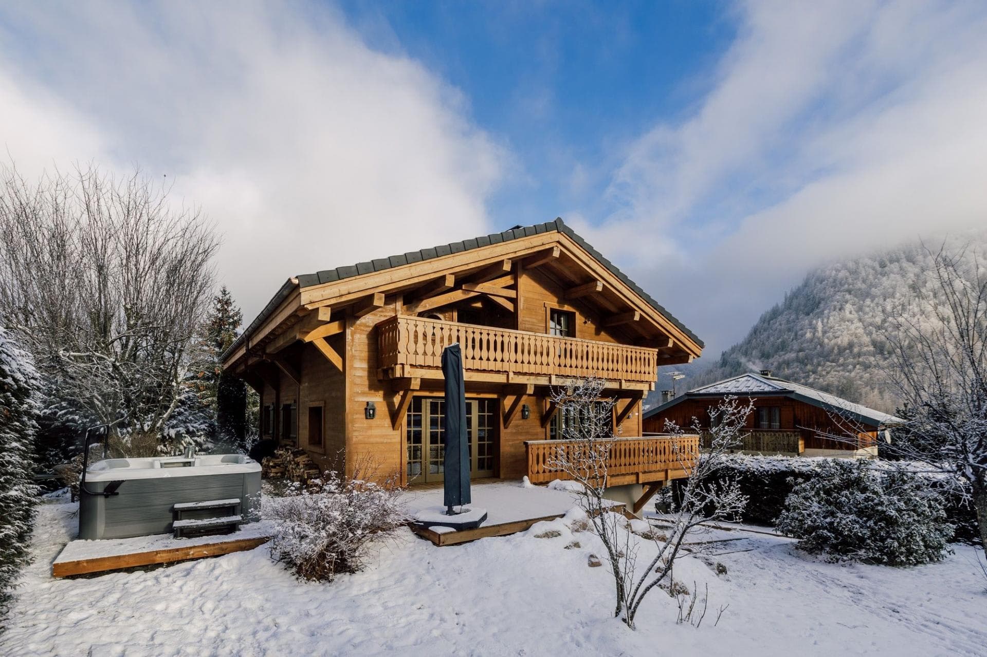 Chalet exterior with ground-floor hot tub and private wraparound balconies