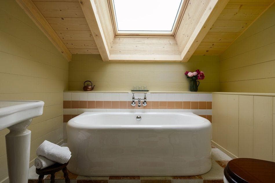 Bathroom with freestanding soaking tub and overhead skylight