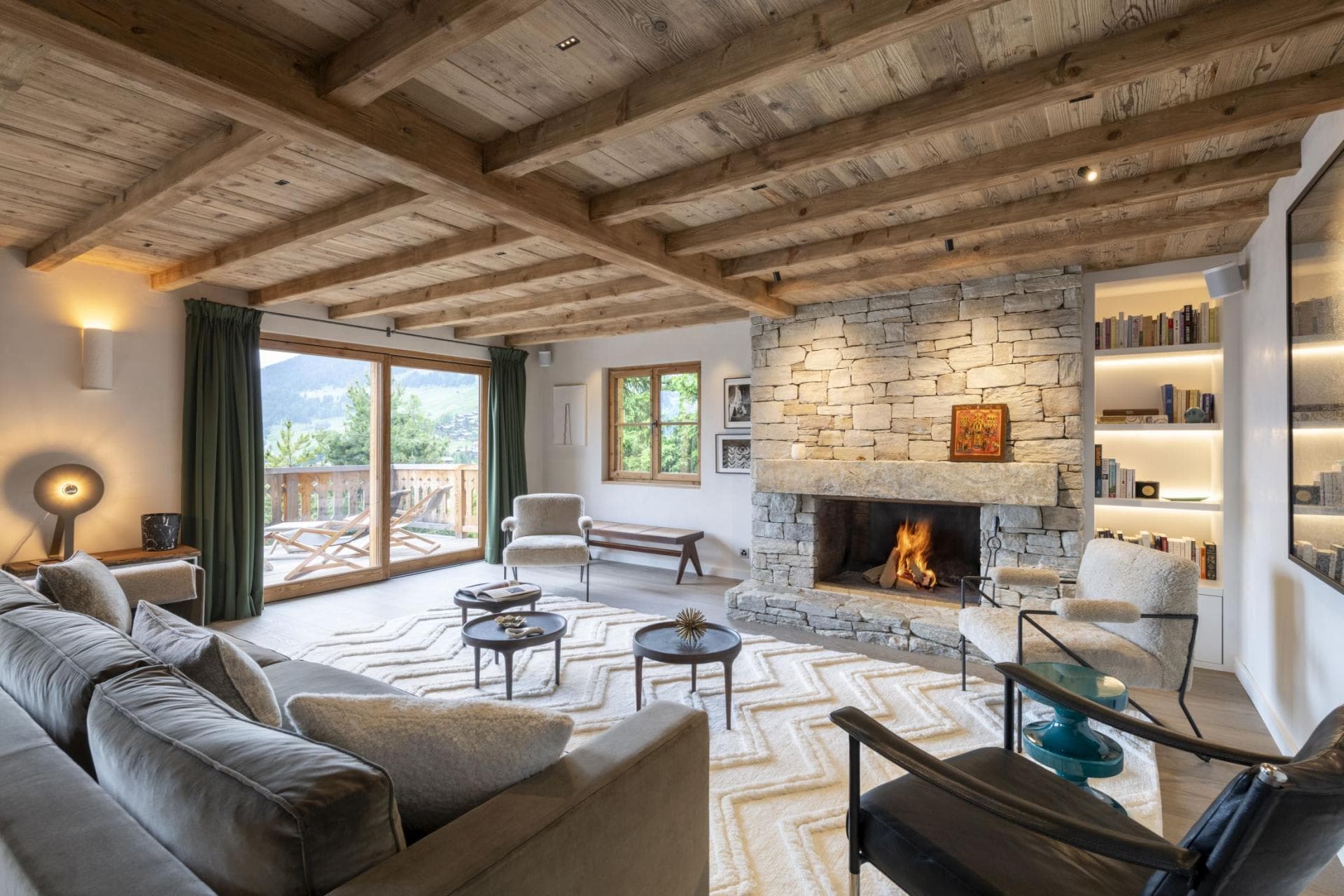 Living area with wood-burning fireplace and balcony access