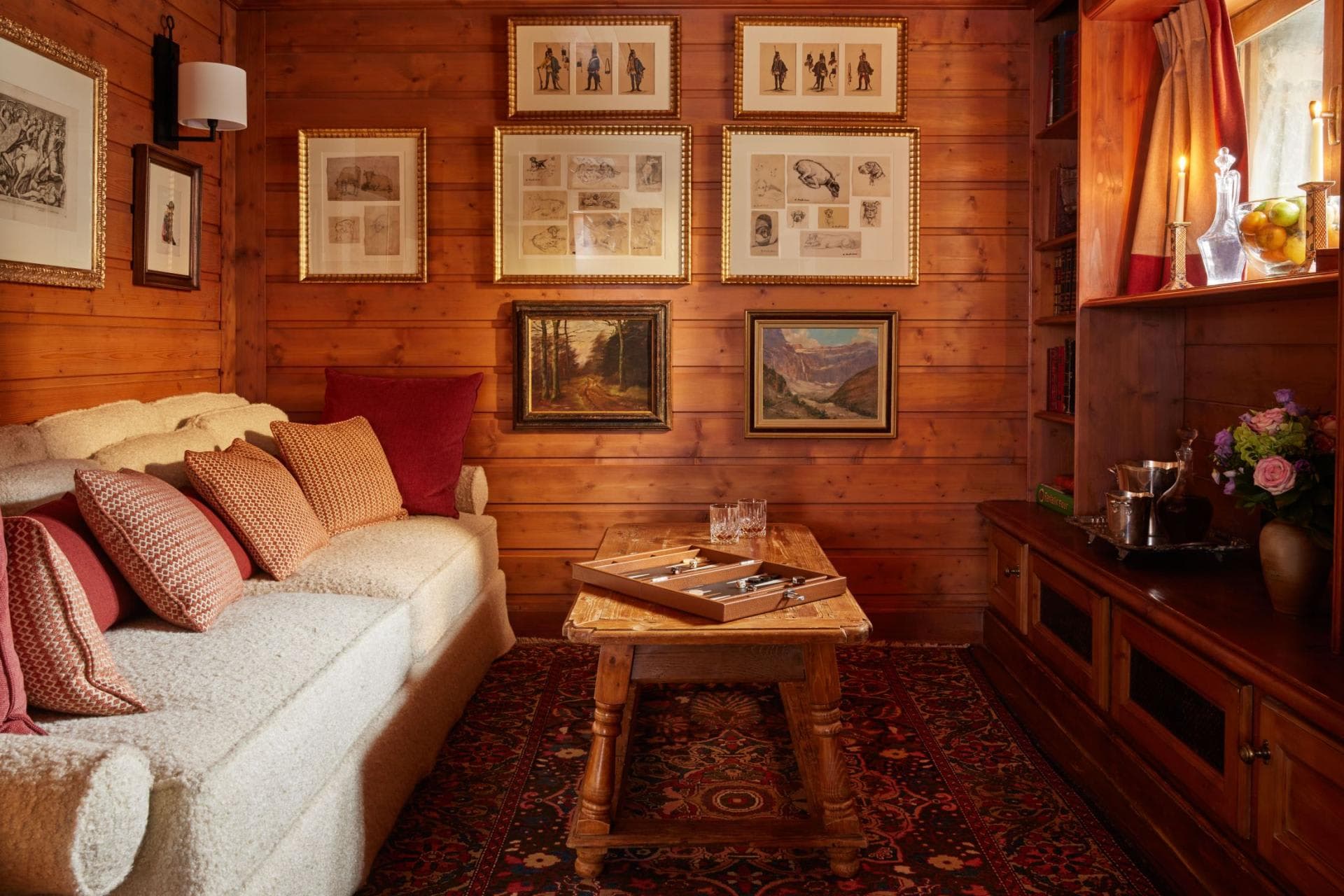 Wood-paneled lounge with backgammon table and integrated bookshelves