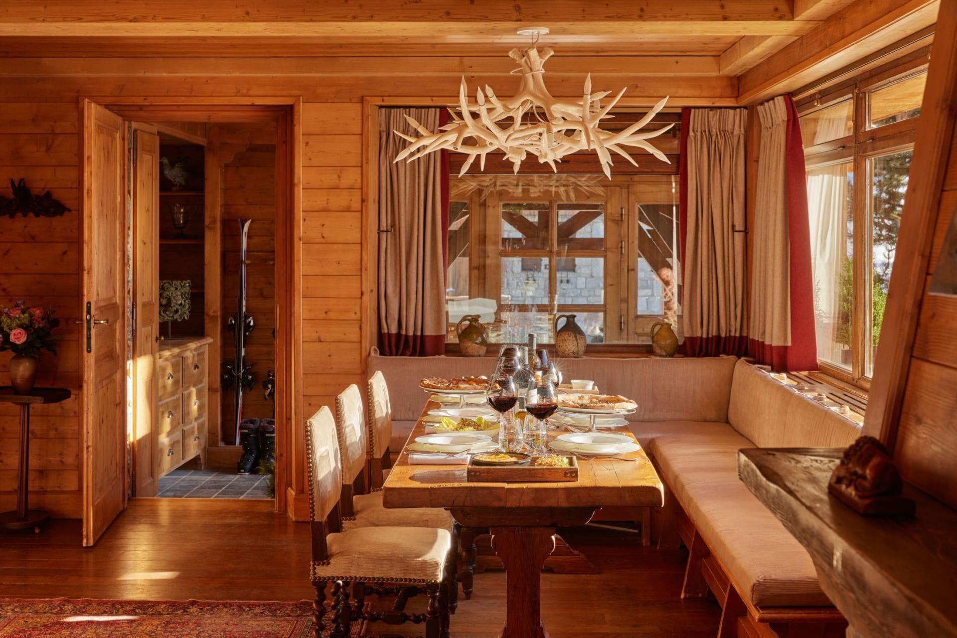 Dining area with banquet seating and adjacent ski storage room