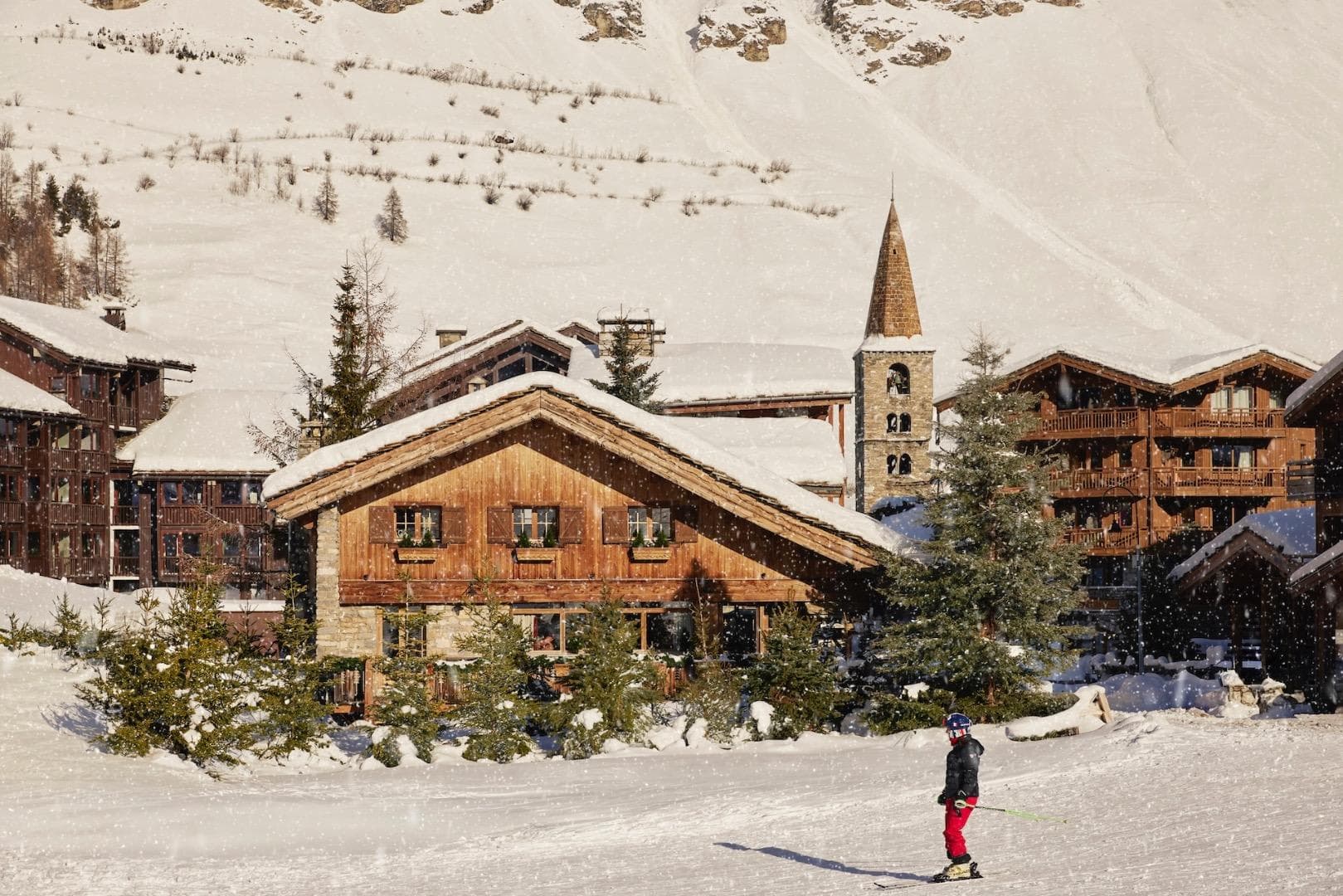 Ski-in/ski-out chalet exterior located adjacent to village church and beginner slopes