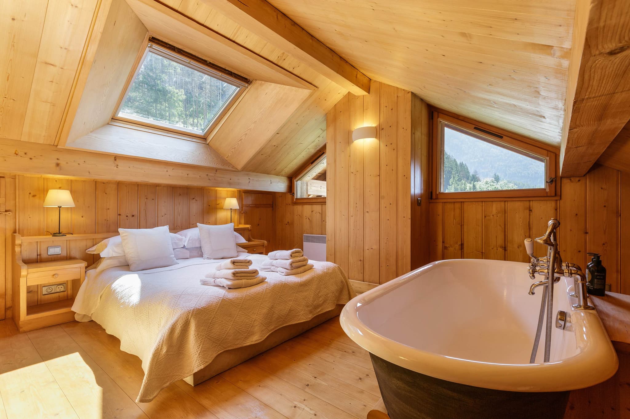 Attic bedroom with king bed, skylight, and in-room clawfoot tub
