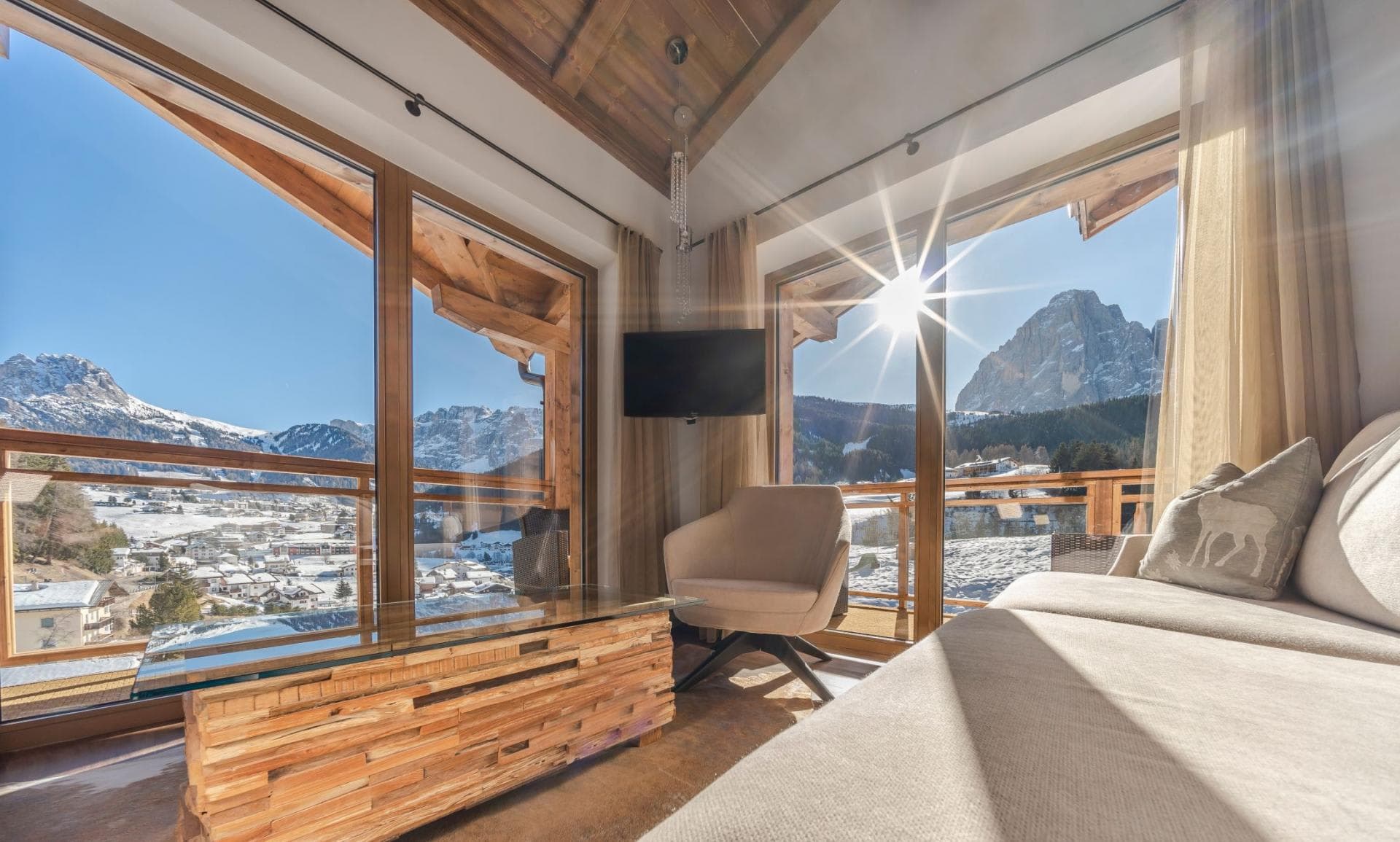 Living area with floor-to-ceiling windows and panoramic Dolomite mountain views