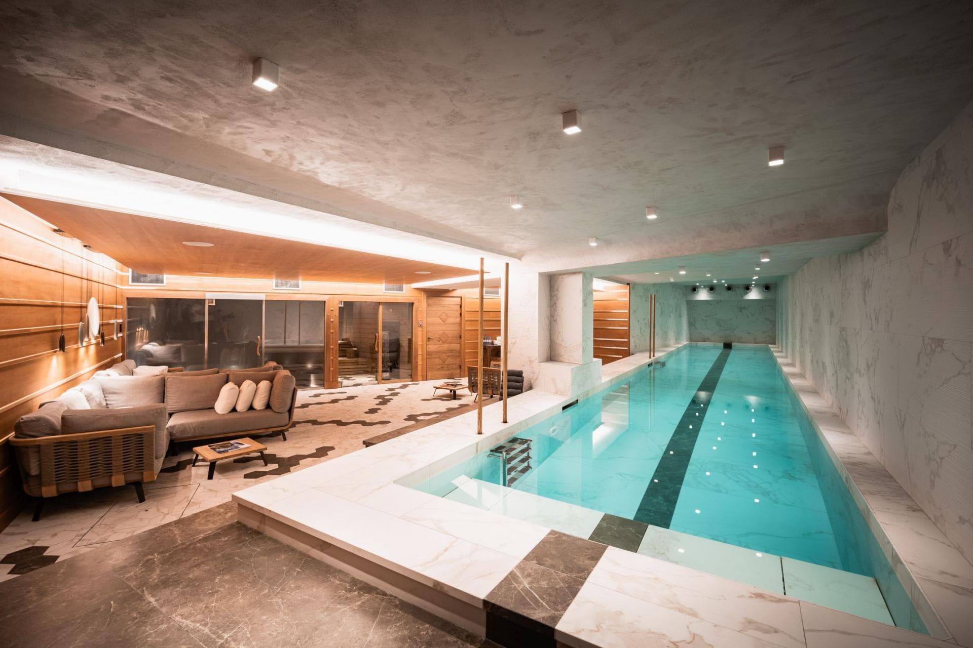 Indoor lap pool with adjacent lounge and sauna access