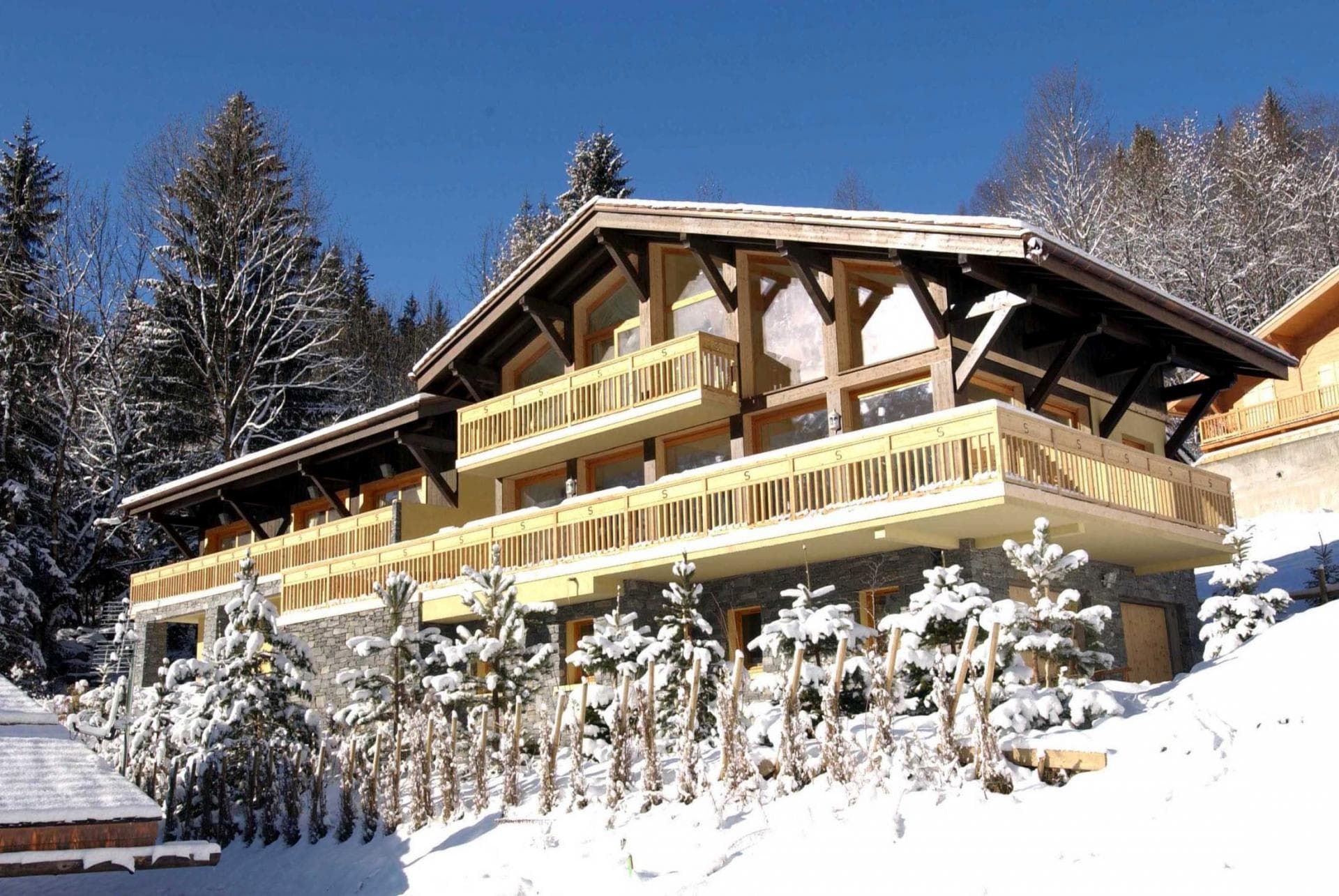 Ski-in chalet with wrap-around balcony and floor-to-ceiling windows
