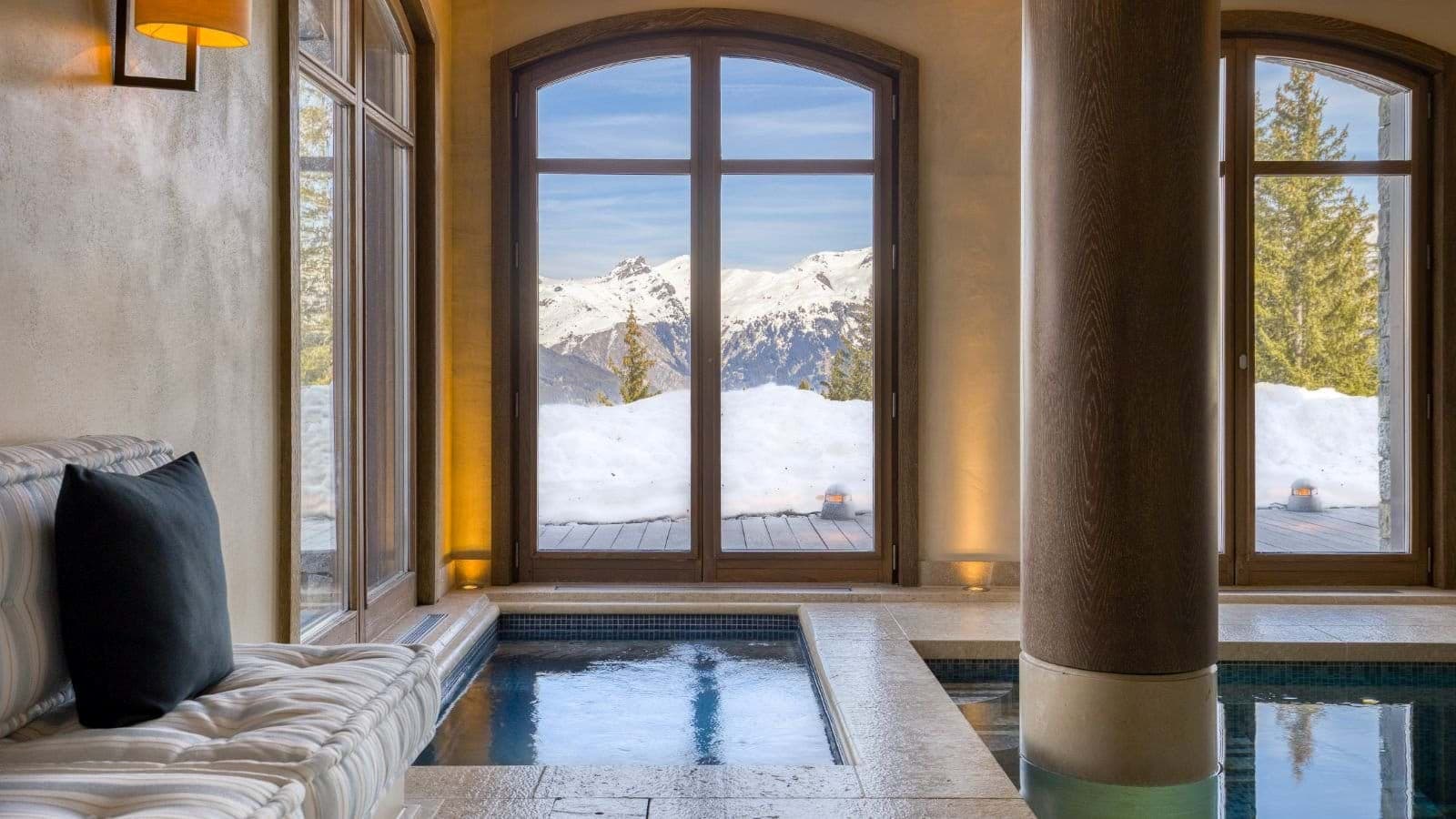 Indoor heated pool and lounge with panoramic Alps views
