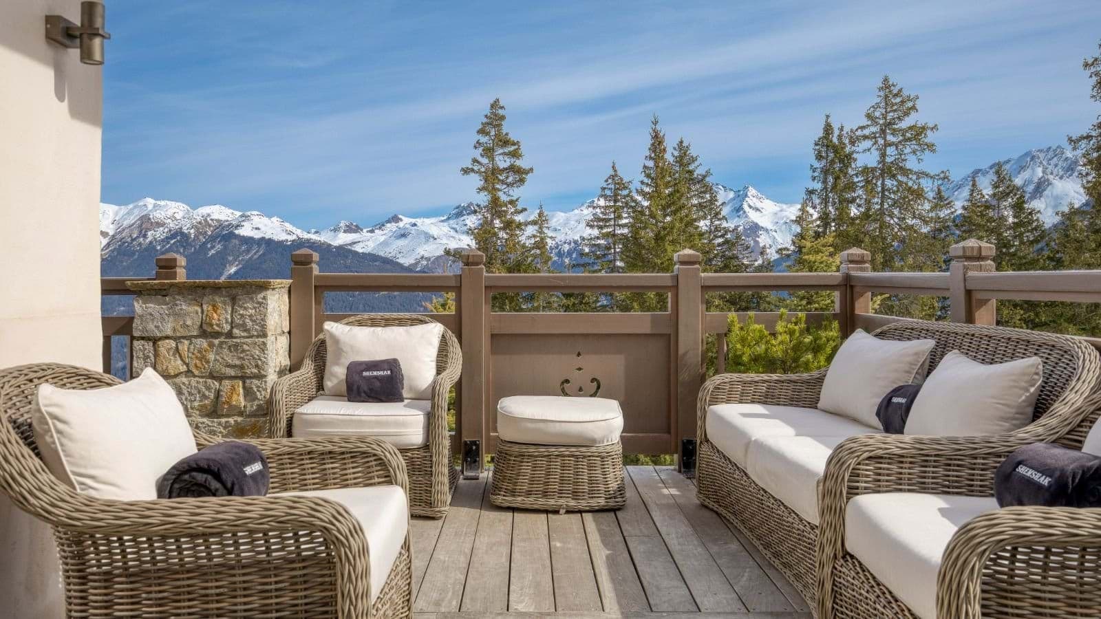 Private deck with wicker seating for 6 and panoramic mountain views