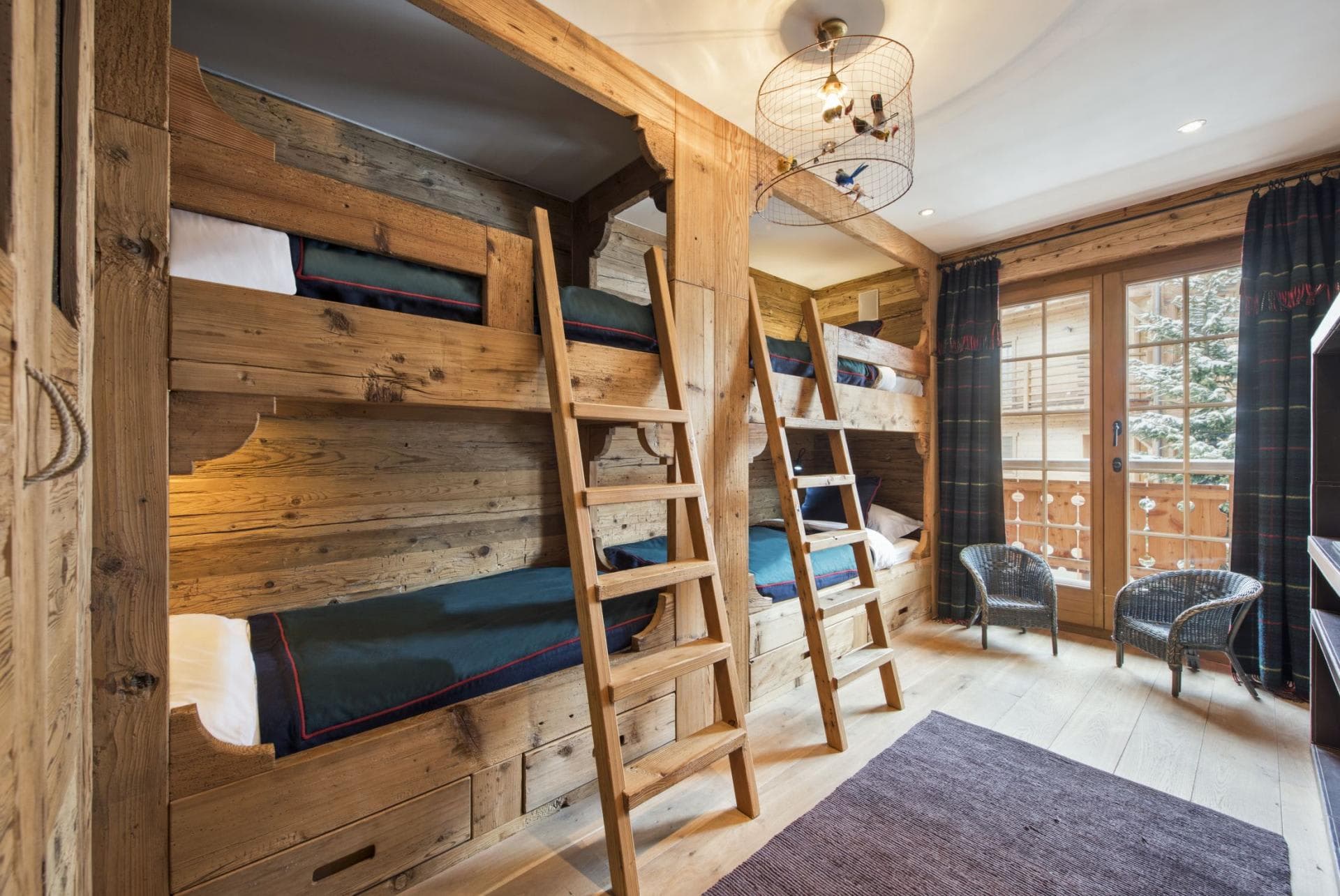Bunk room sleeps 4 with reclaimed wood frames and balcony access