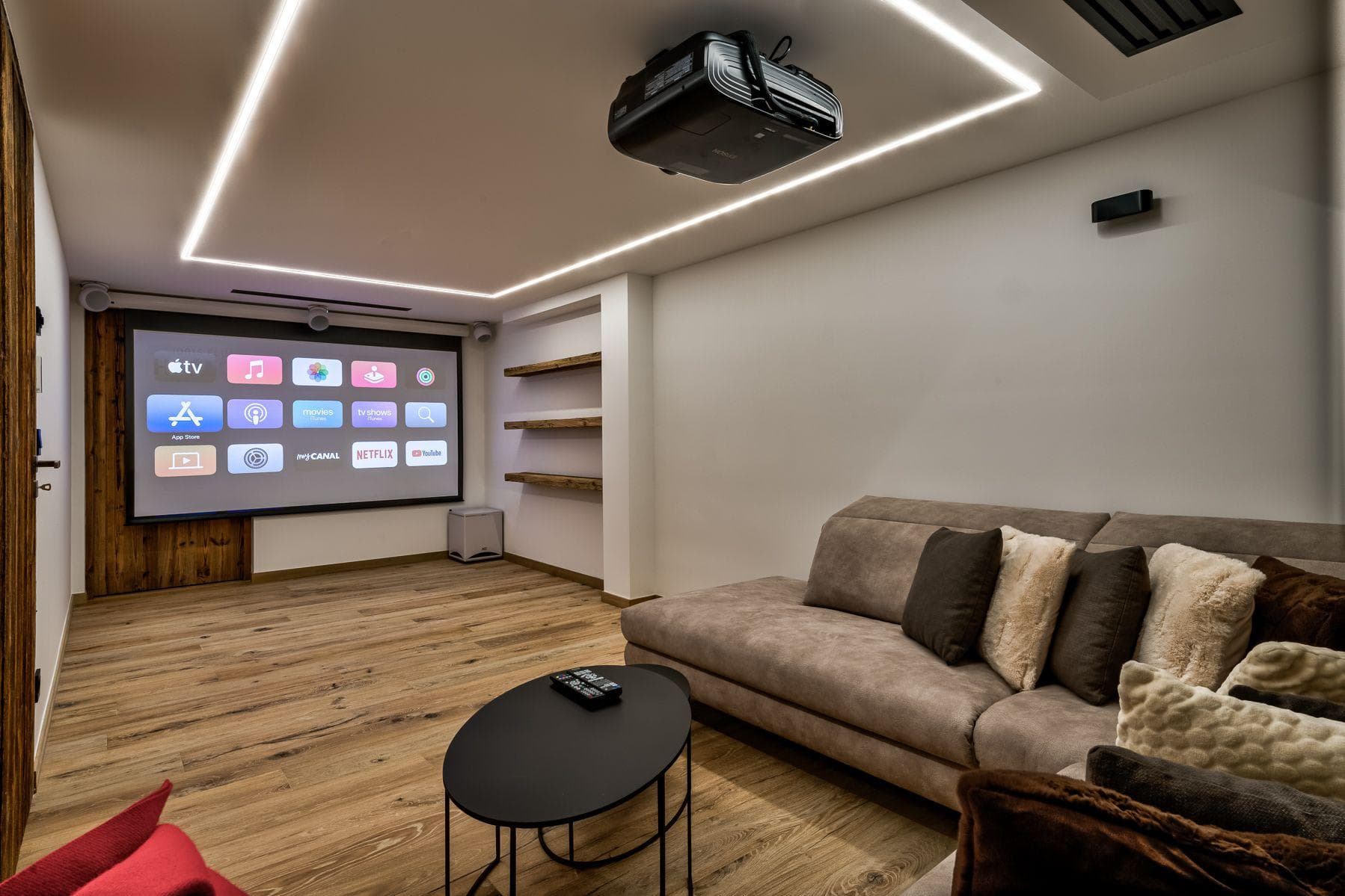Media room with ceiling-mounted projector and Apple TV smart interface