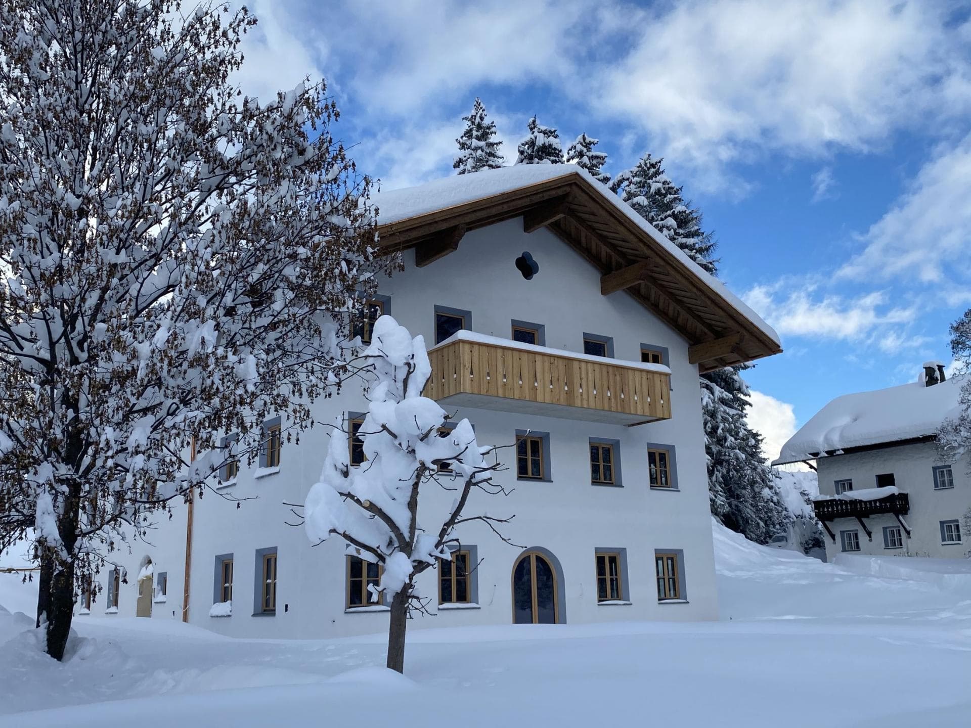 Chalet exterior featuring private balcony and snow-covered grounds