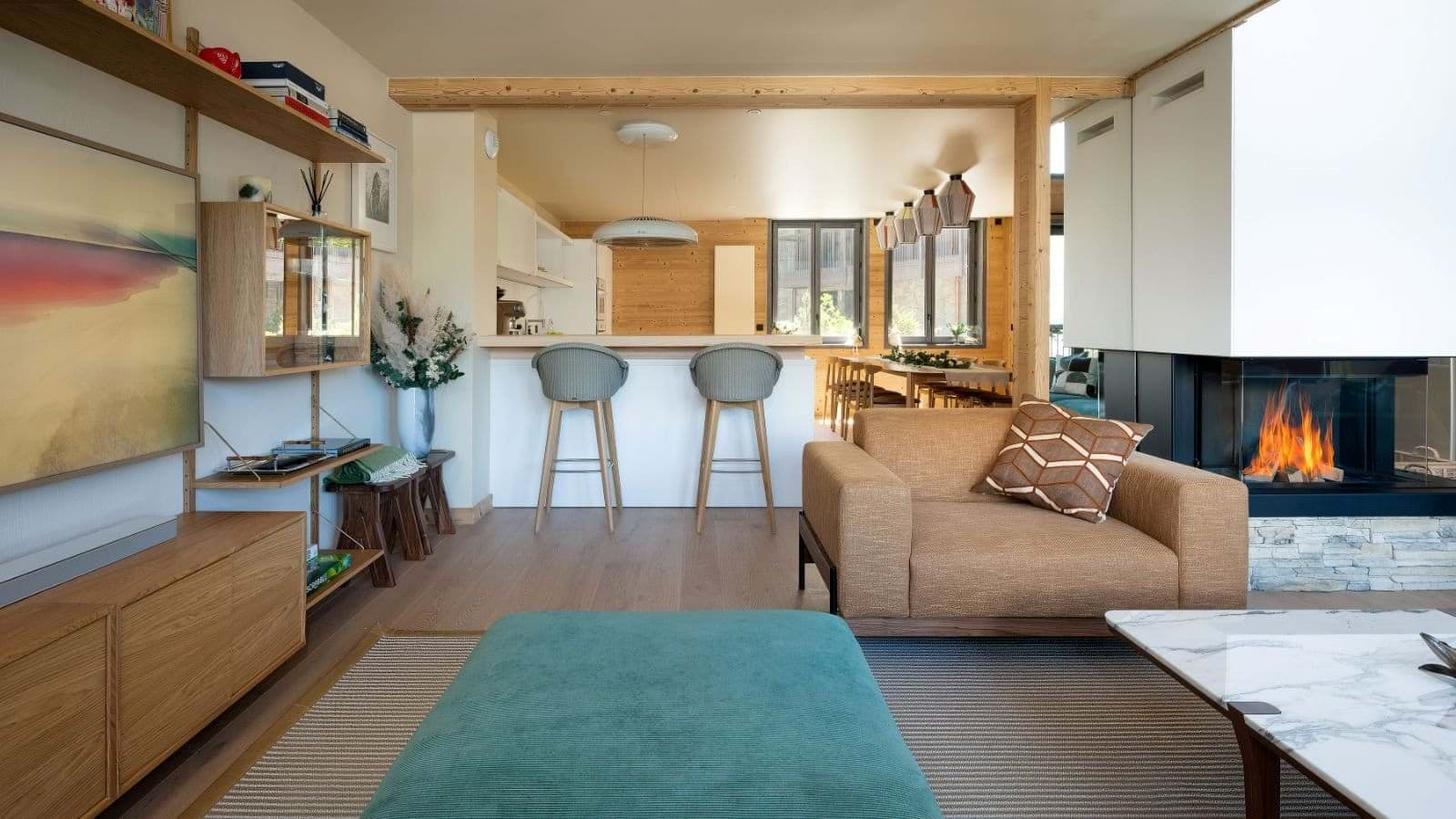 Open-plan living area with wood-burning fireplace and breakfast bar seating