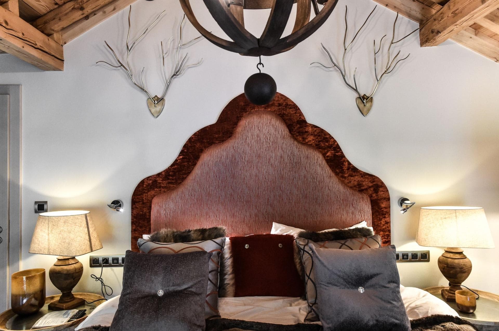 Bedroom with vaulted wood ceiling and bedside reading lights